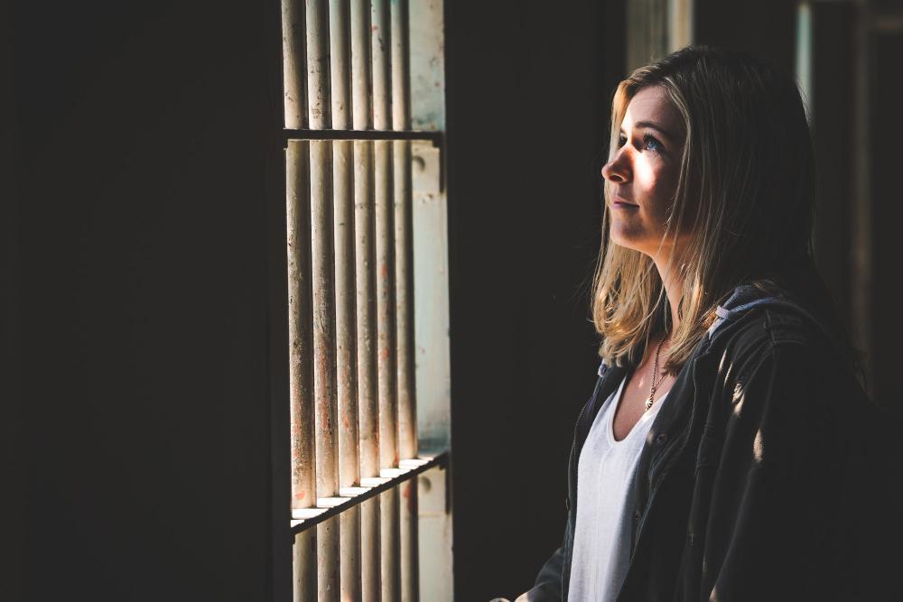 A photograph of a woman in jail