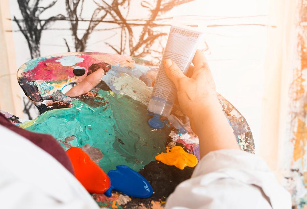 A photograph of an artist mixing paint