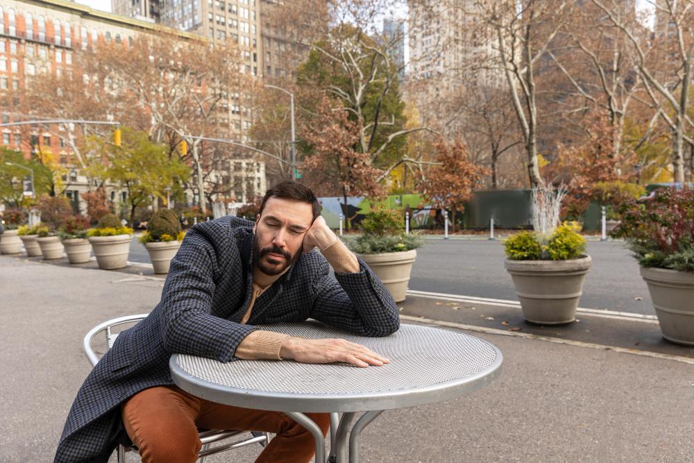 A photograph of a man relaxing outside