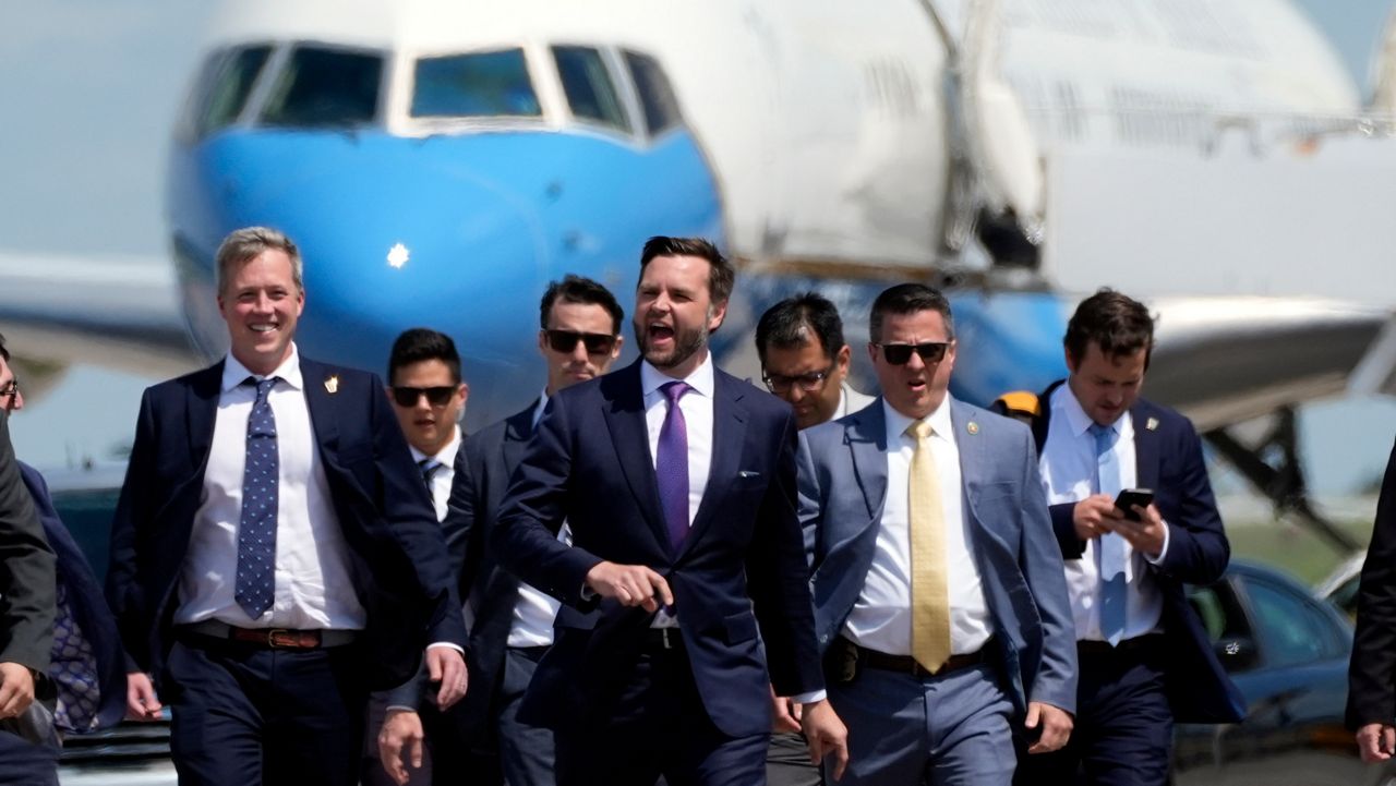 JD Vance walking with his personal security team outside of Air Force Two