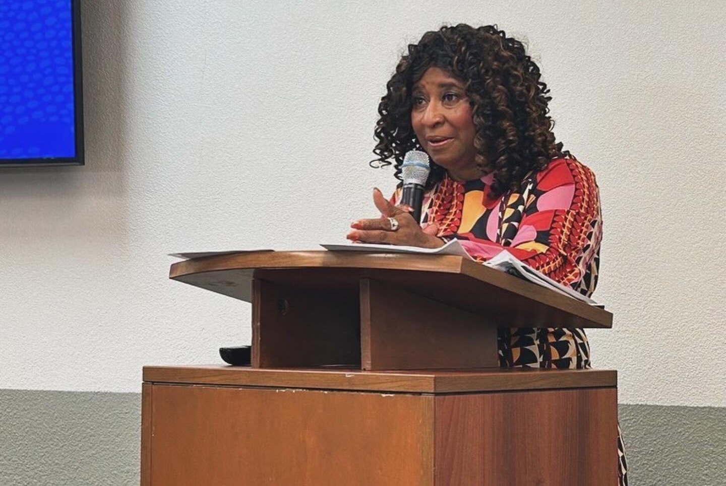 Pamela Price speaking at a podium