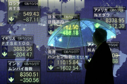 A man walks past an electronic board showing the closing price of Japan's Nikkei share average on October 27, 2008 in Tokyo, Japan. The 225-issue Nikkei Stock Average lost 486.18 points, or 6.36 percent, its lowest close since October 7, 1982.  