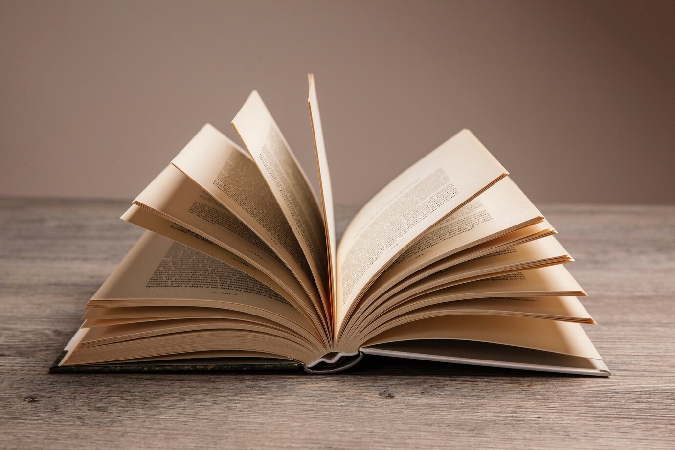 Opened book on a wooden table