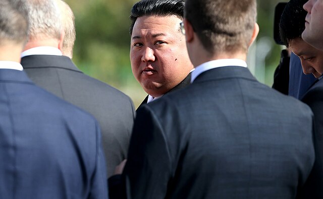 Kim Jong Un and security personnel