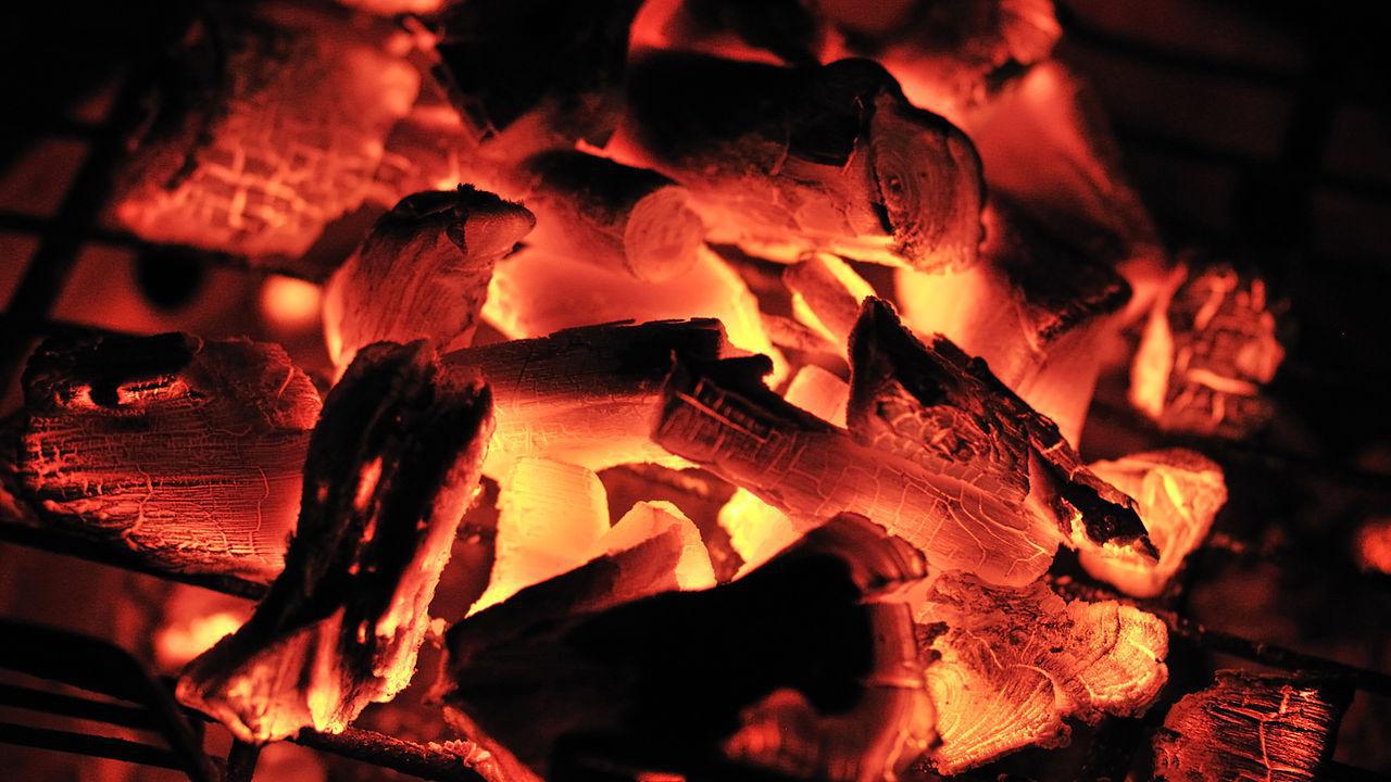 A photograph of charcoal burning in a fire
