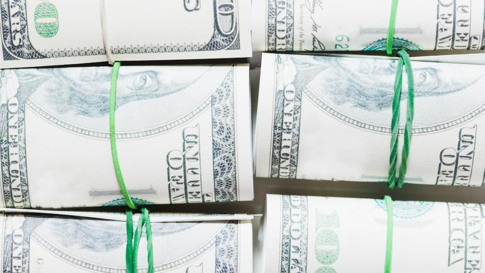 A photograph showcasing bundles of American cash