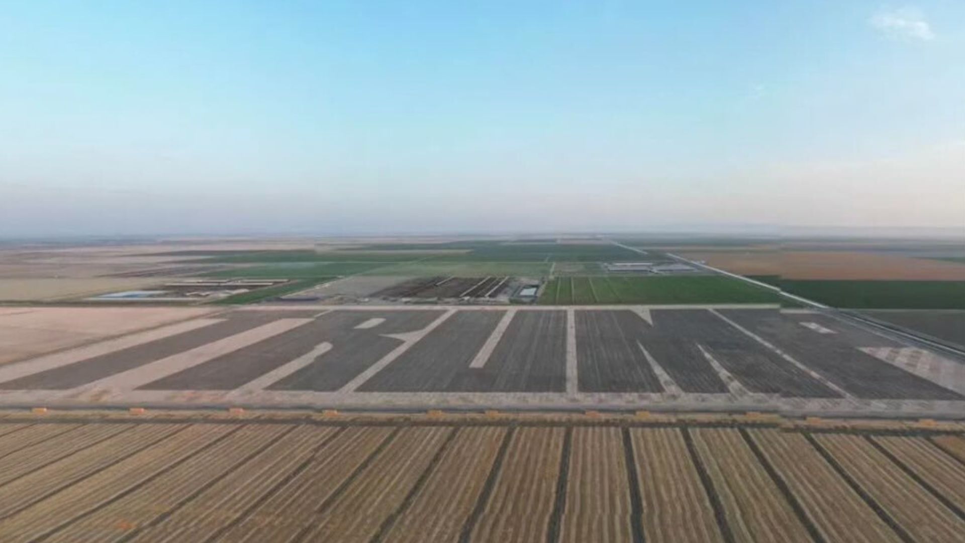 A large TRUMP sign in a field