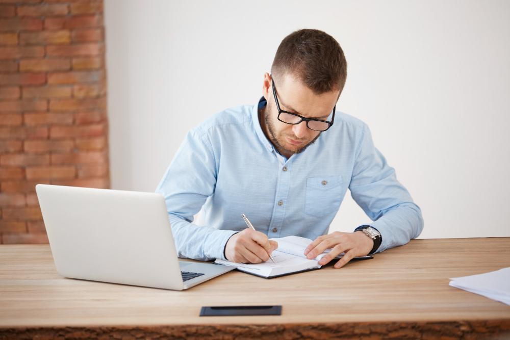 A photograph of a male researcher working at his desk