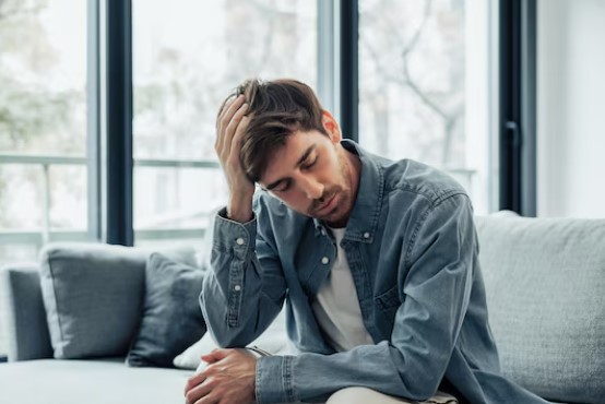 Man sitting down fatigued