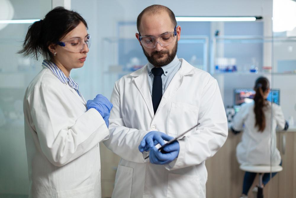 A photograph of two scientists checking test results in their lab