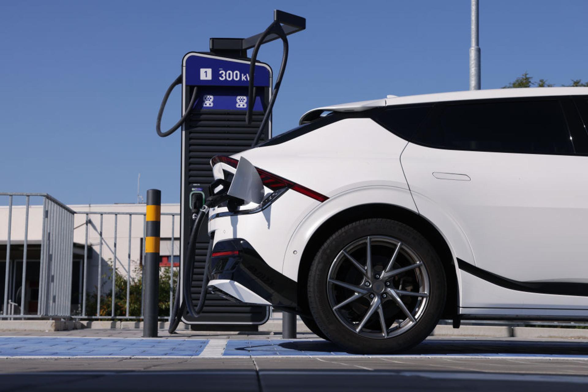 An electric car charges at a public charging station