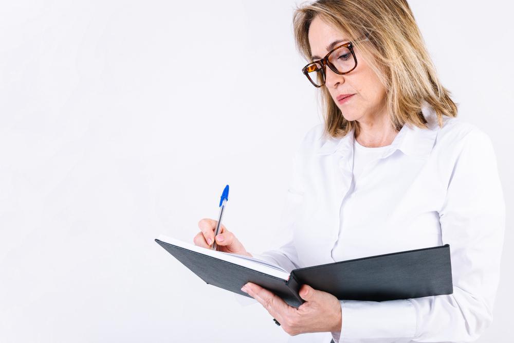 A photograph of a scientist writing in a notebook
