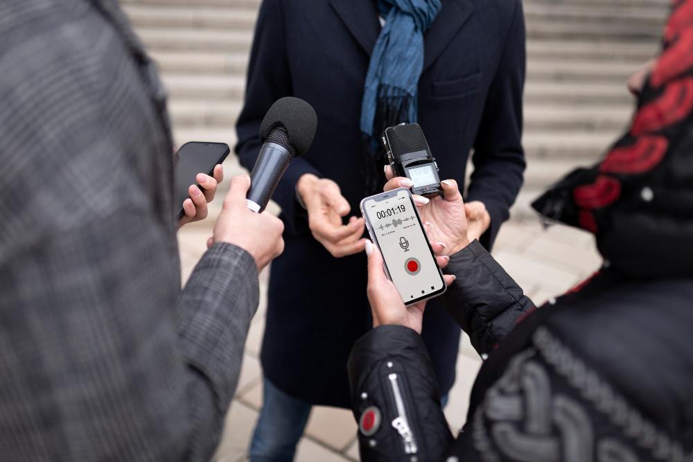 A photograph of several reporters on the street