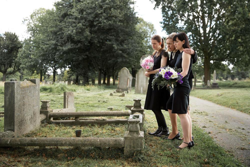A photograph of a family around a gravesite