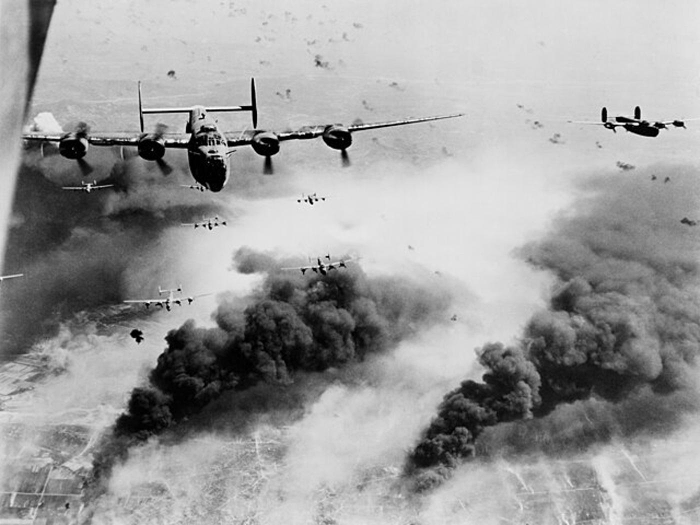A black and white photograph of planes releasing bombs on Germany during WWII