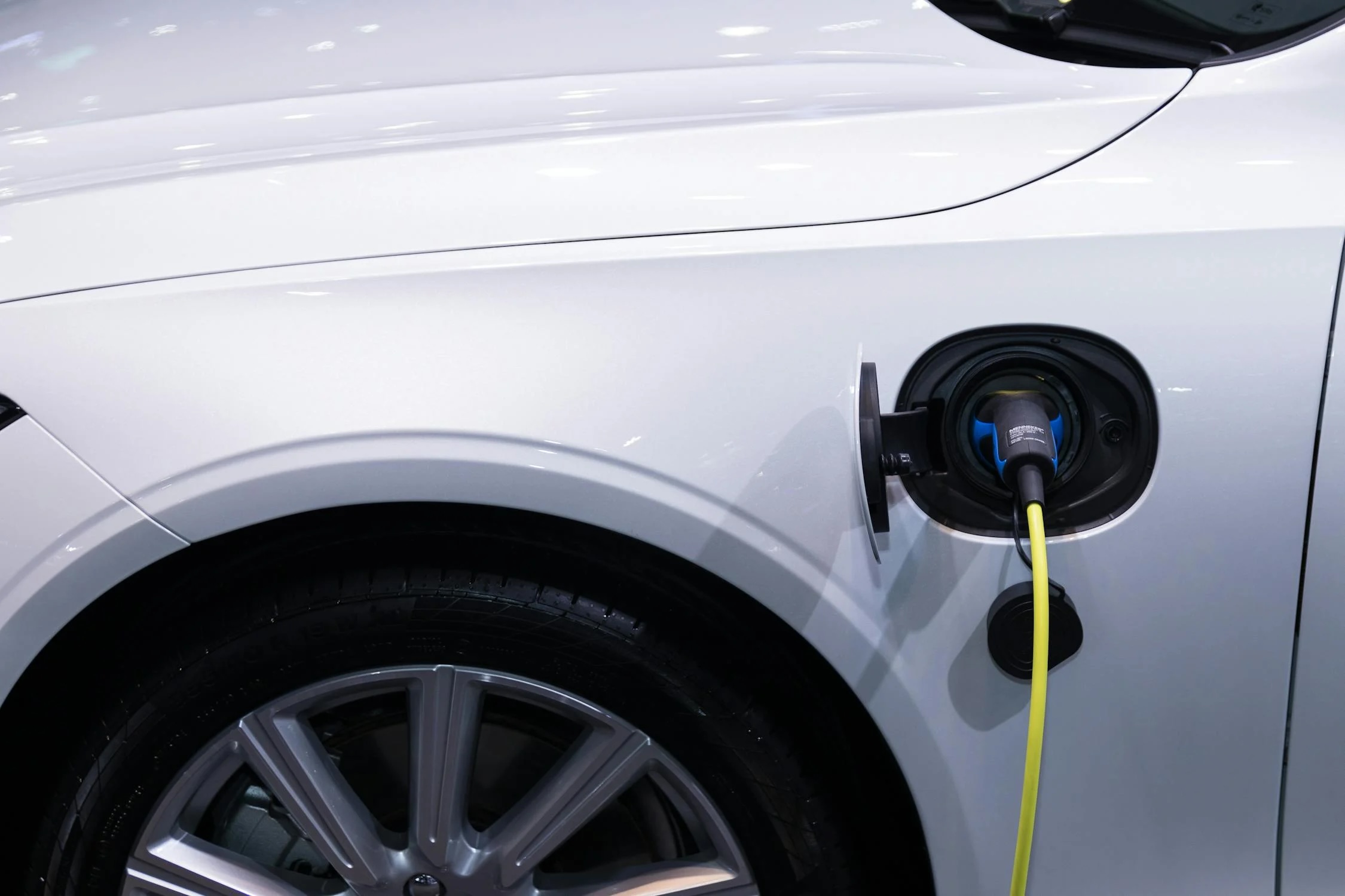 A white Tesla charging