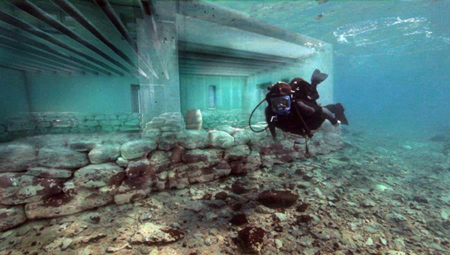 A diver is pictured exploring several underwater ruins