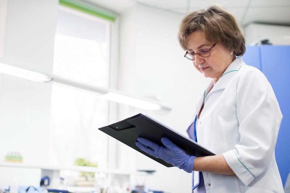 A photograph of a female scientist looking at a report