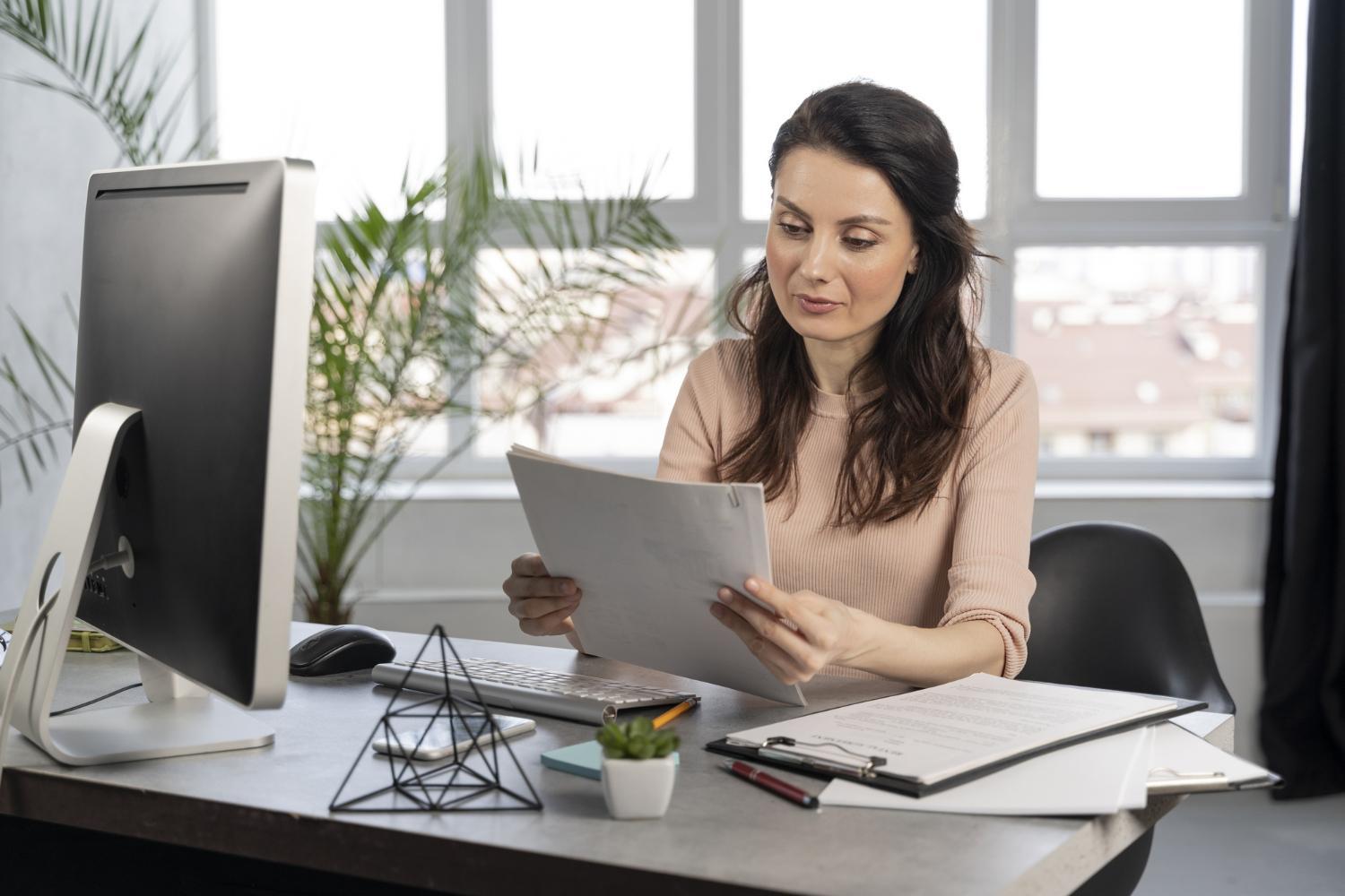 A photograph of a woman reading a report