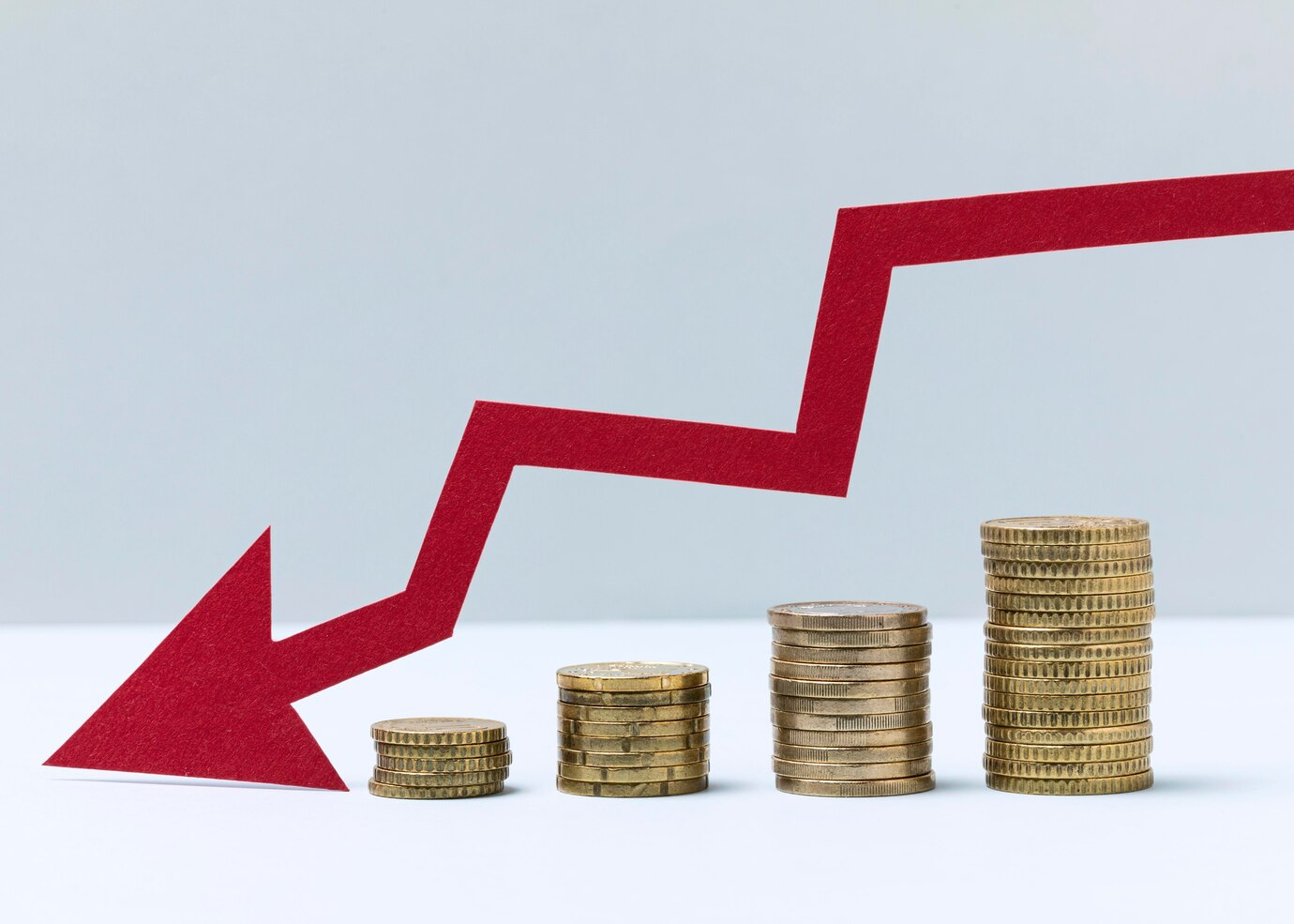 Coins and downward red arrow