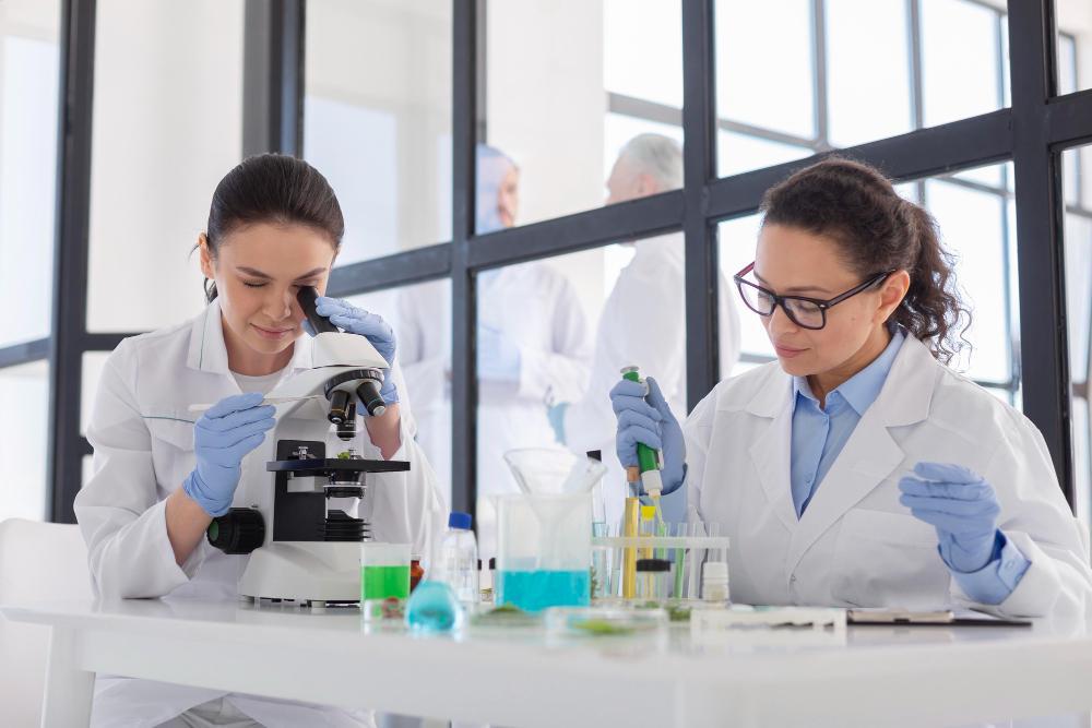 A photograph of two female scientists working in their lab