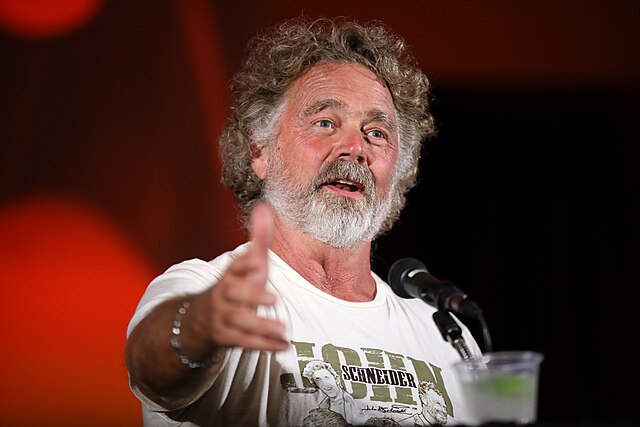 John Schneider speaking at an event