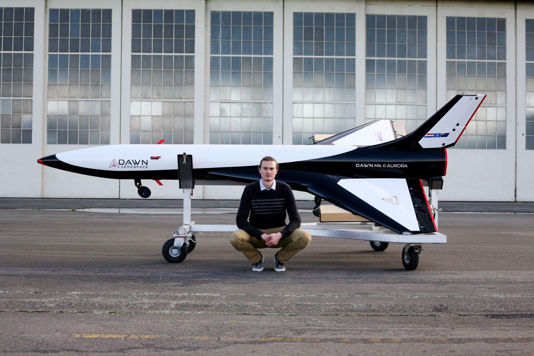 A photograph of an engineer beside a miniature Mk-II