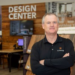 LL Flooring CEO, Charles Tyson standing with his arms crossed