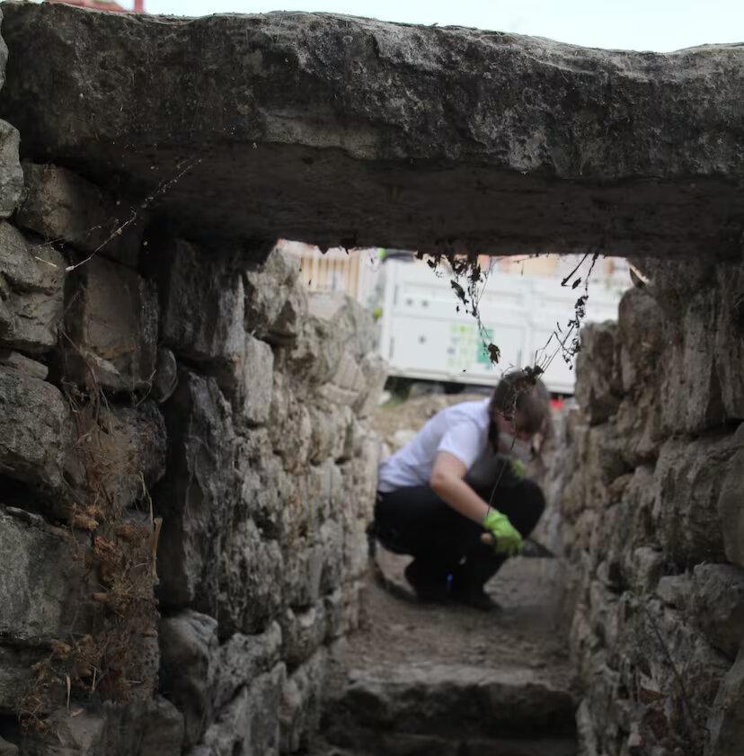 A photograph of an archaeologist working at the site of Marroquíes Bajos