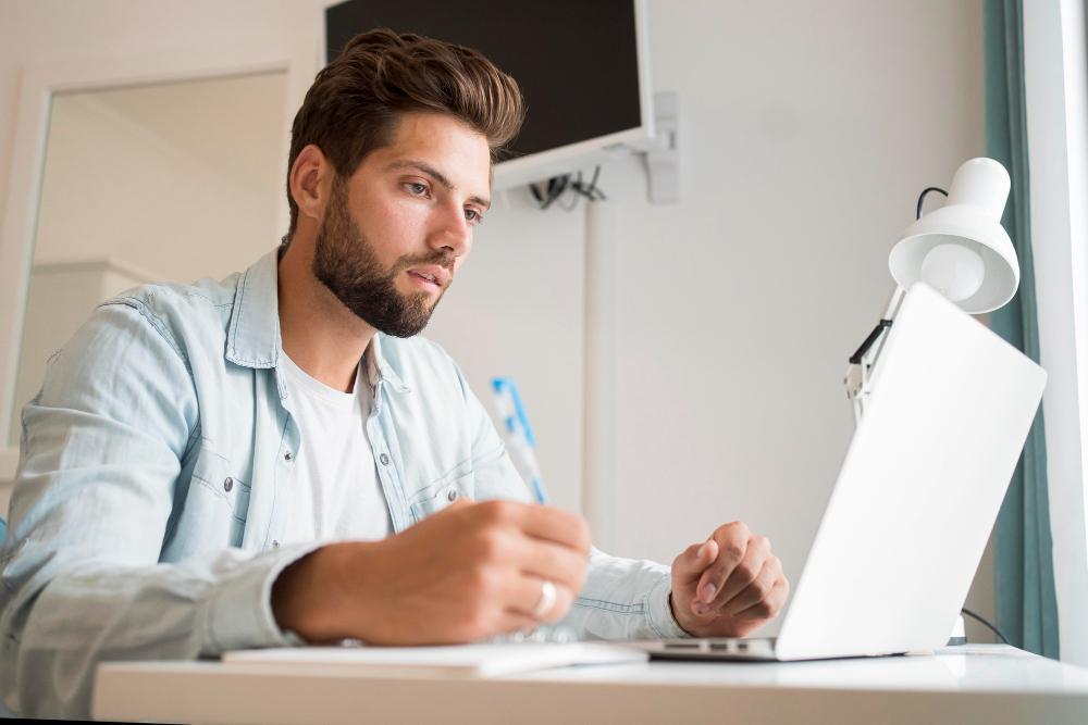 A photograph of a researcher pictured at his desk